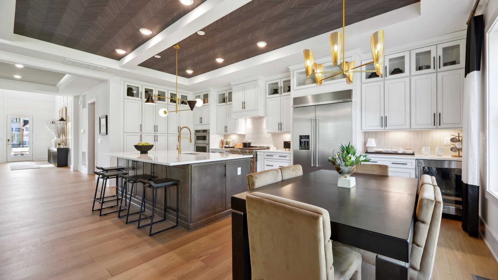 casual dining table has a view of the kitchen and foyer