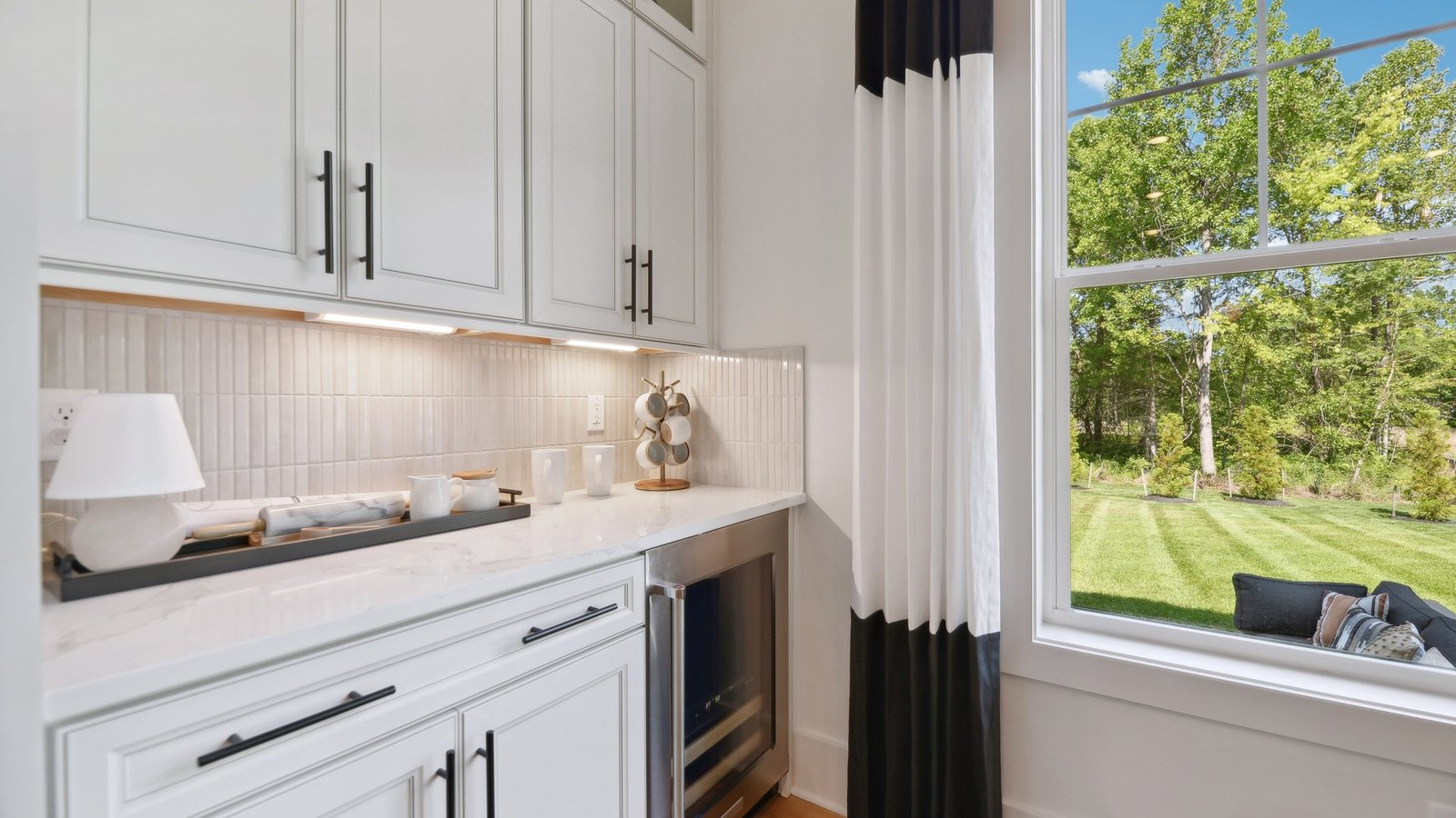 The kitchen space includes a wine cooler