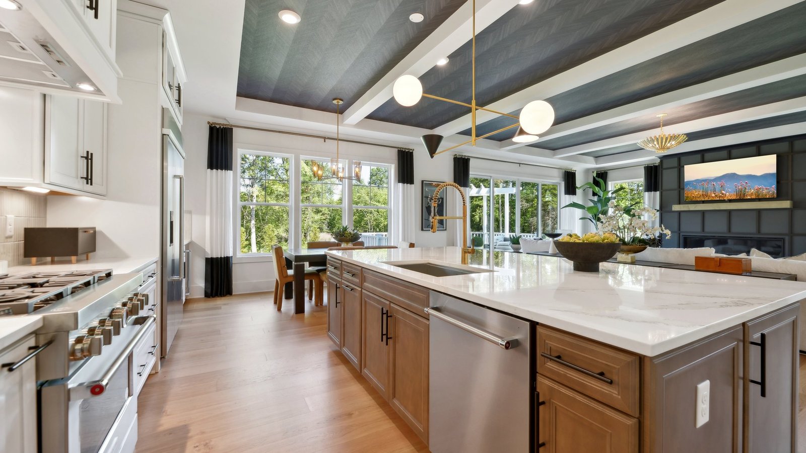 The large TV above the fireplace is perfect from viewing from the large, sofa, dining table, or kitchen