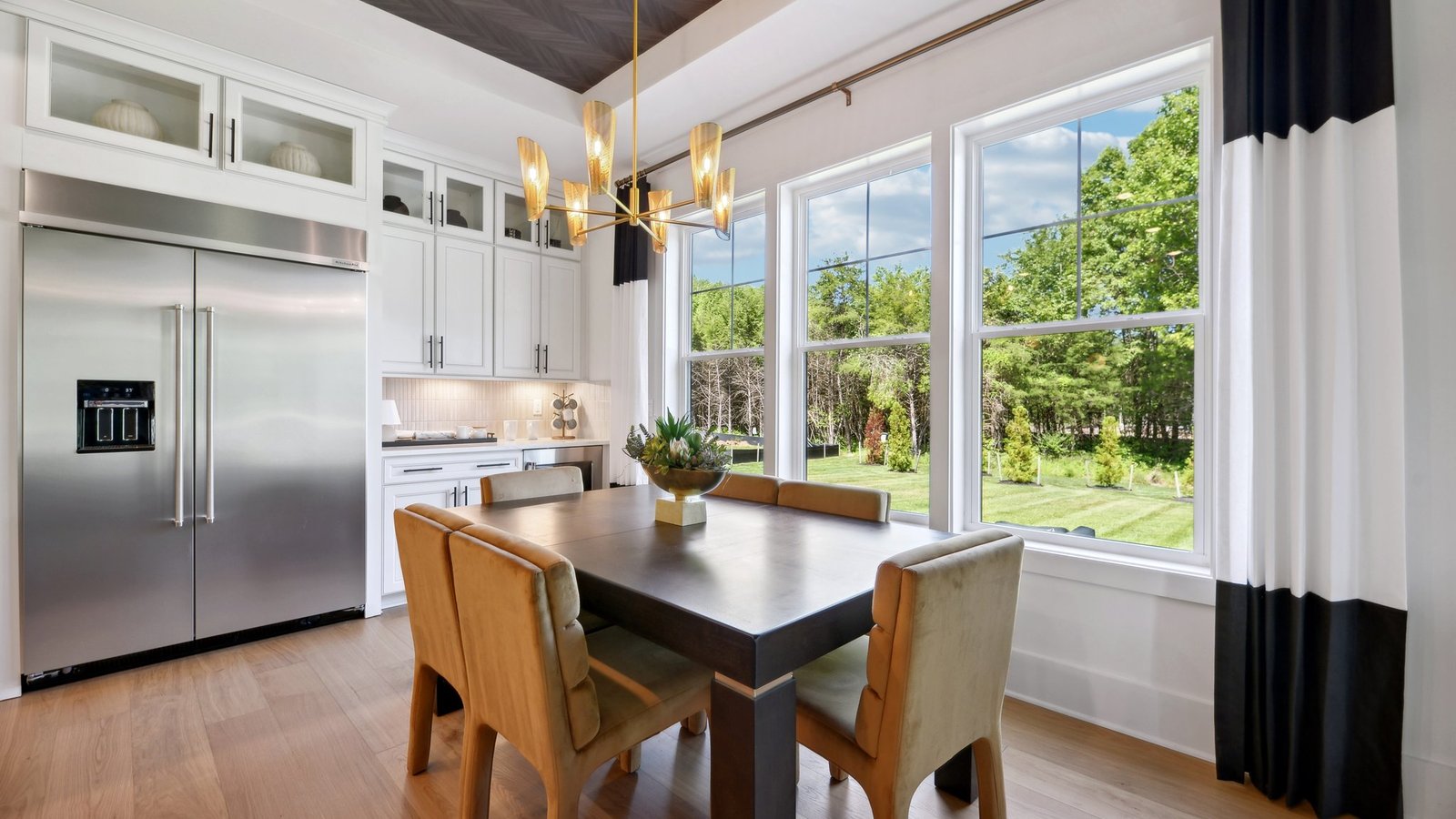 Casual dining space is located right next to the kitchen and overlooks 3 large windows