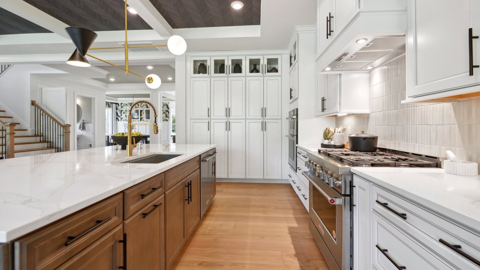 large luxurious kitchen island includes a sink and plenty of space to cook or eat