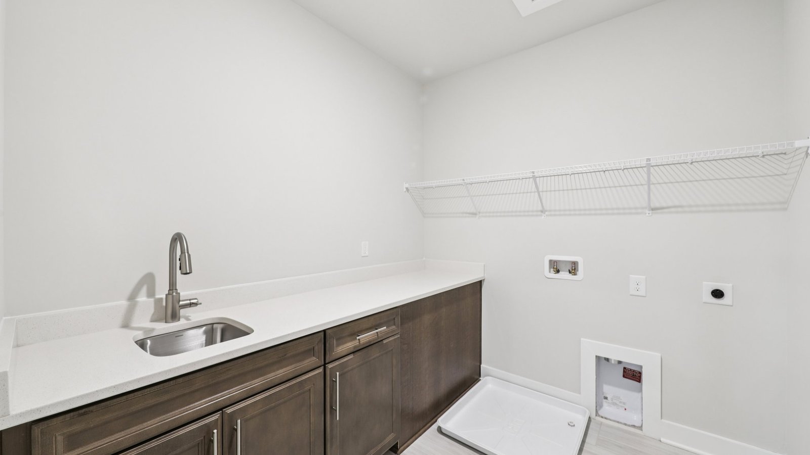 laundry room features a sink and a large folding counter