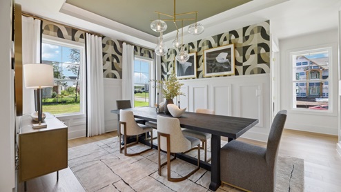 formal dining features a long rectangular table and 2 windows that provide plenty of natural light