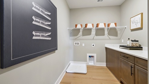large laundry room with cabinets and folding counter