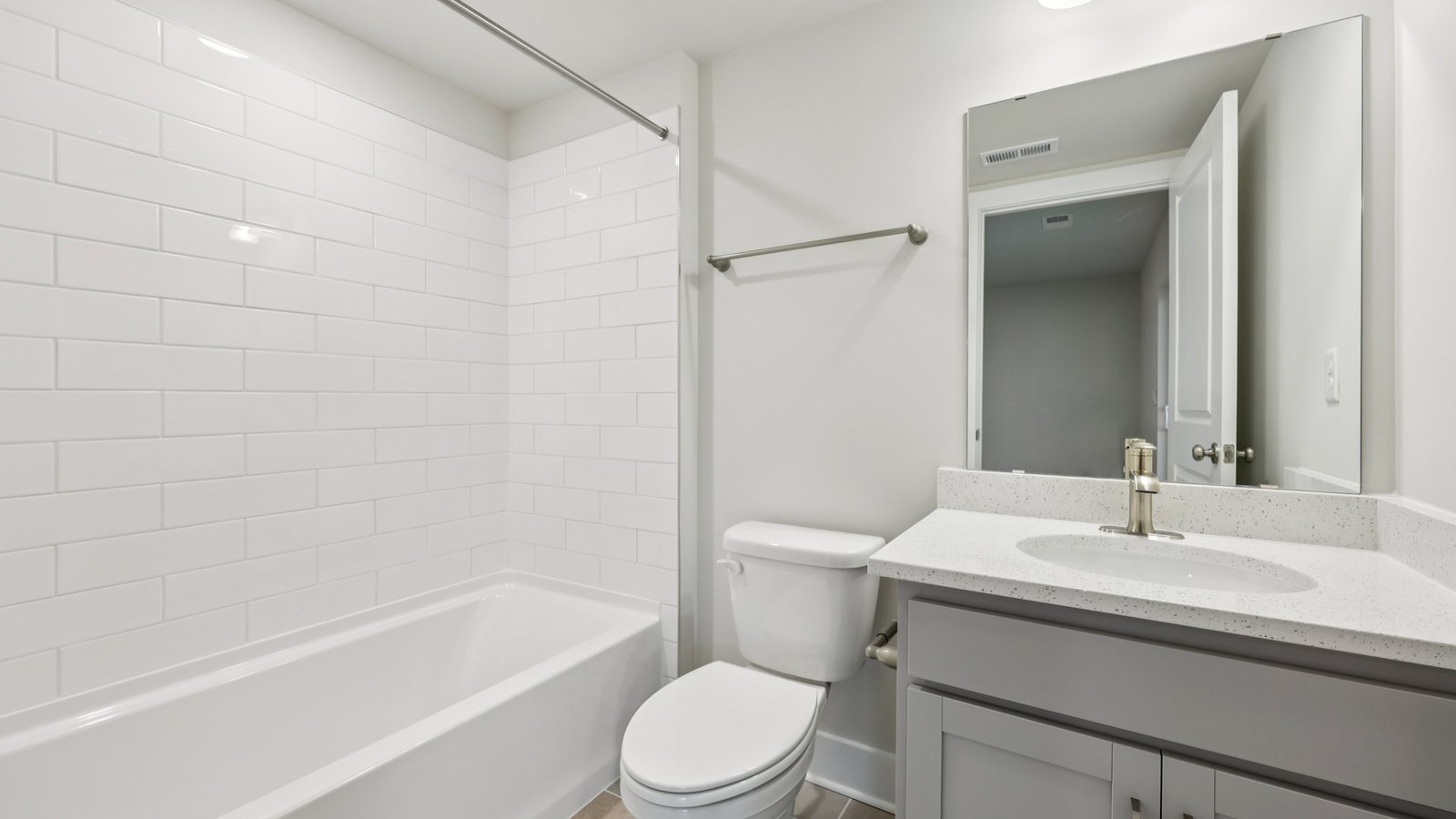 Bathroom — grey vanity and tub-shower with subway tile