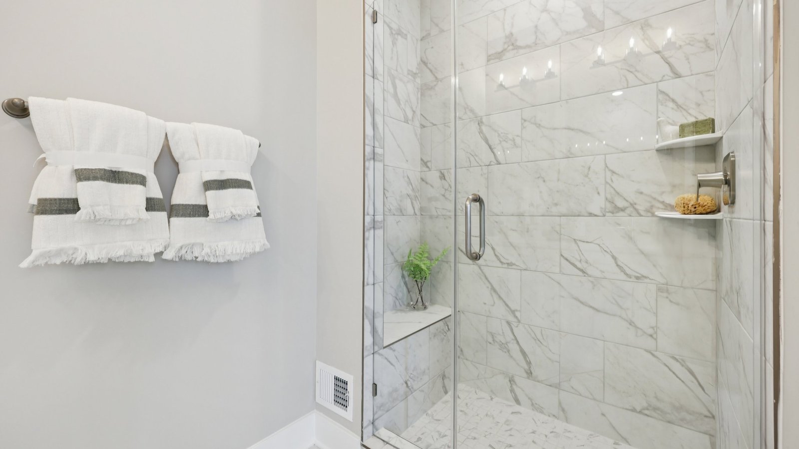 modern full bath with double vanity and walk in shower