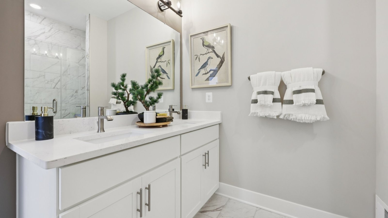 modern full bath with double vanity and walk in shower