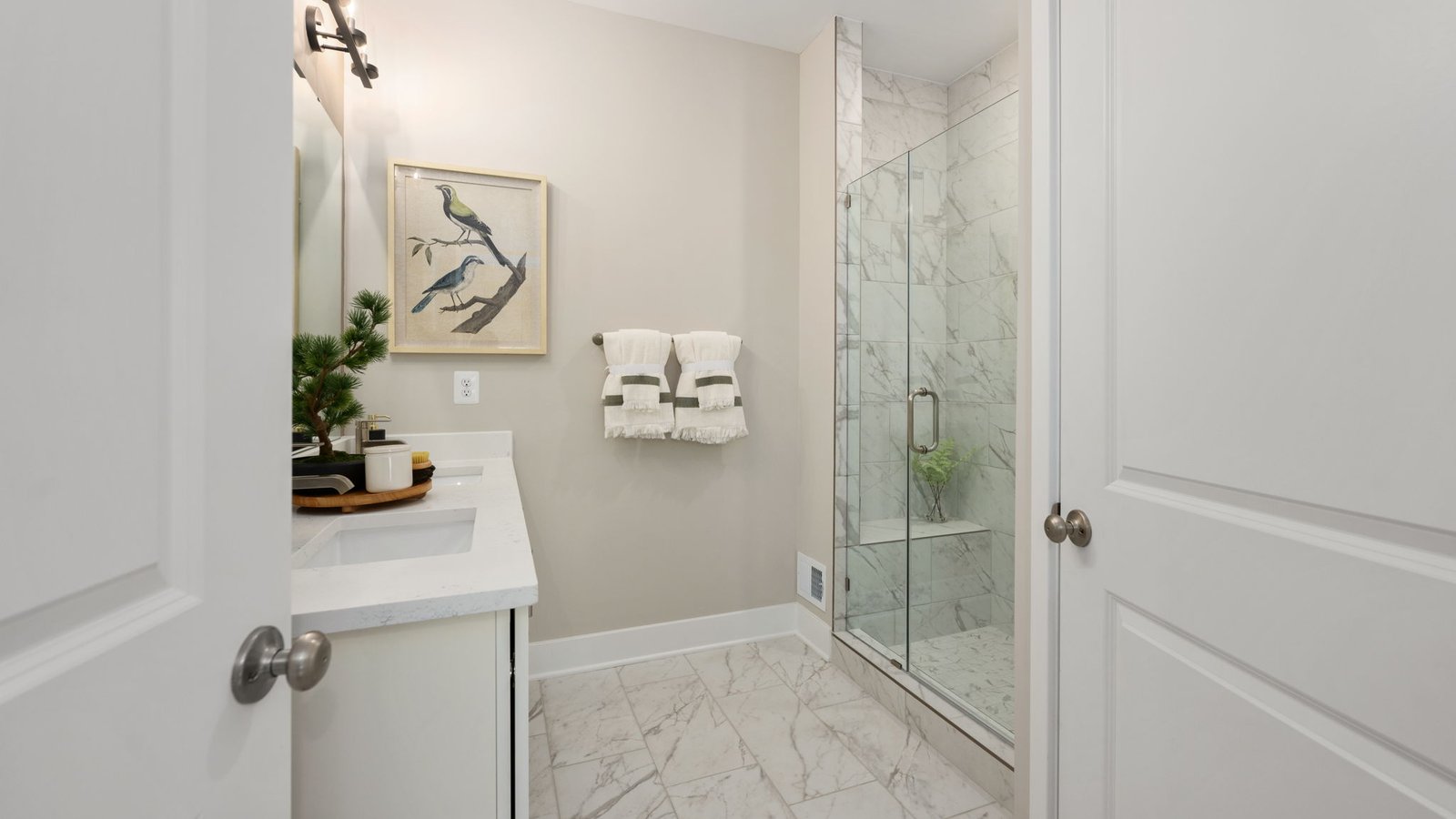 full primary bathroom with walk in shower and dual sink vanity