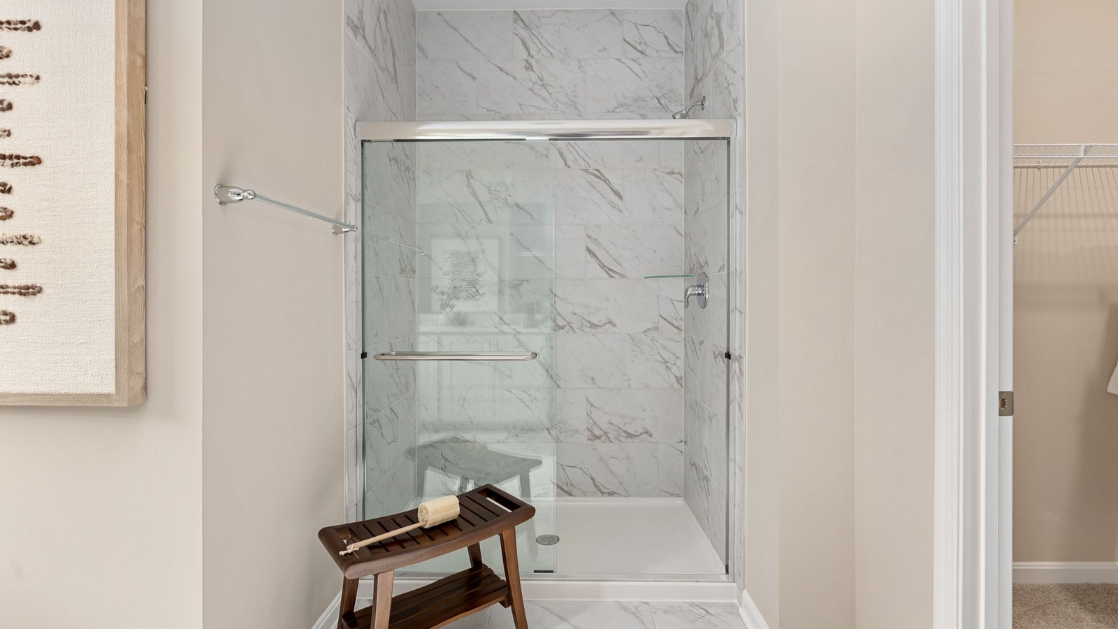 Modern primary bathroom in a new King George, VA home with dual vanities and a spacious shower.