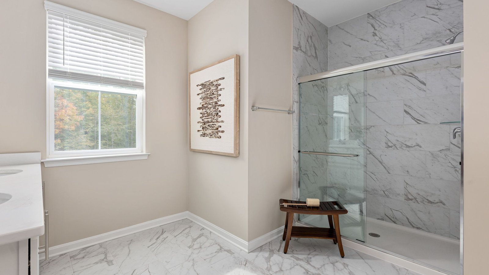 Modern primary bathroom in a new King George, VA home with dual vanities and a spacious shower.