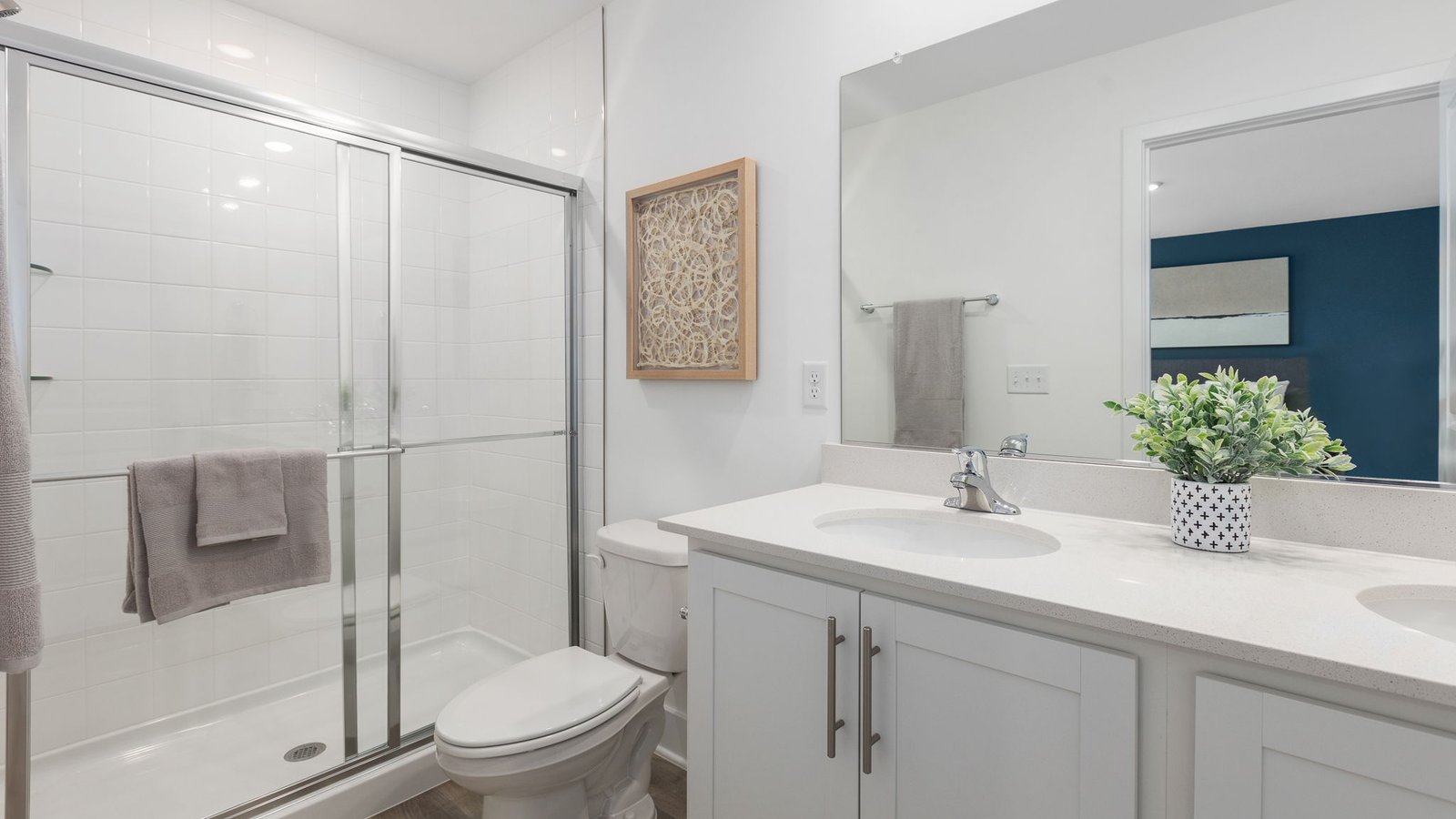 primary bathroom with dual sink vanity and walk in shower