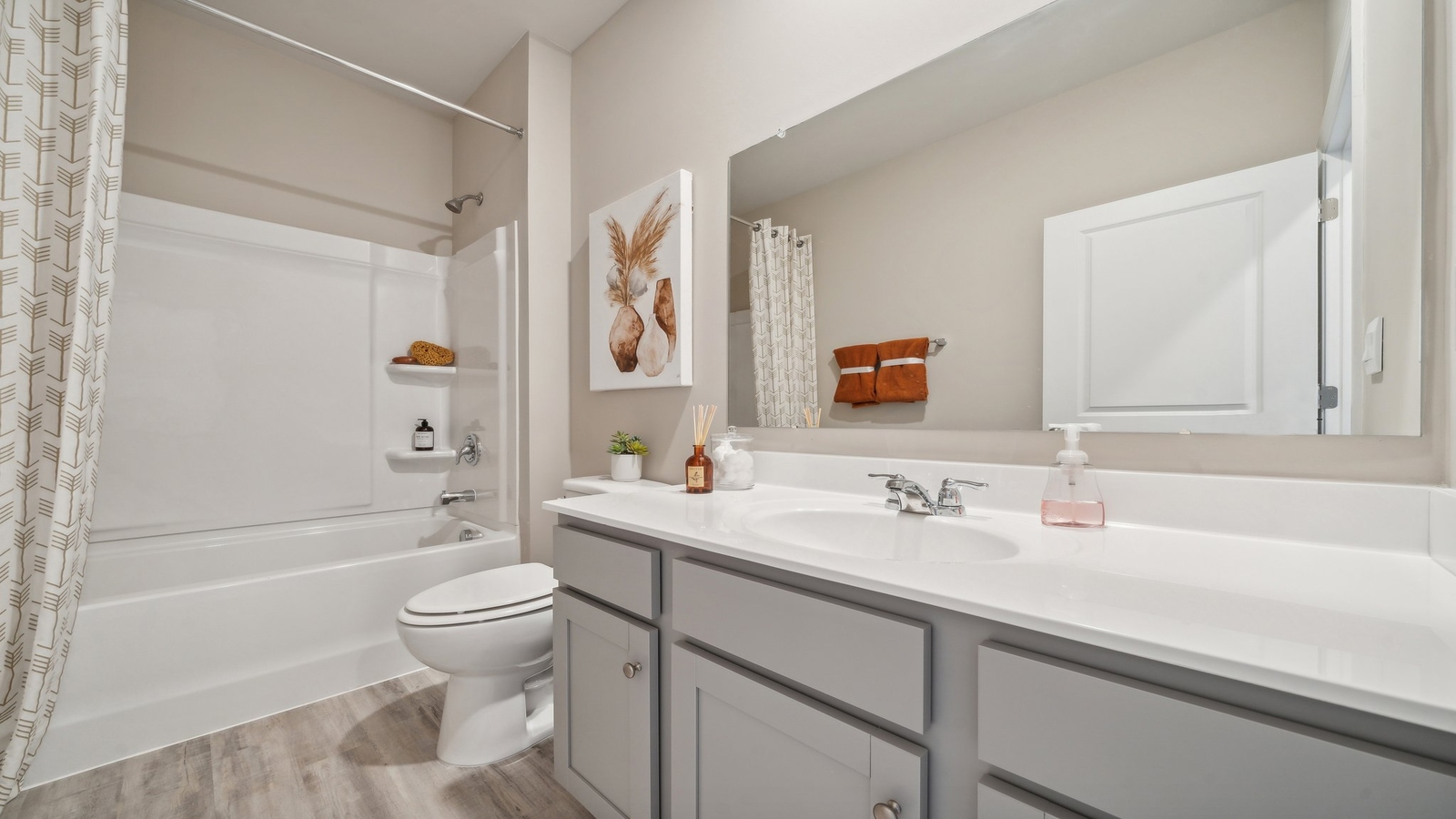 Secondary bathroom adds quality with a combination shower-tub, cabinet storage, vanity, mirror at Eagle Ridge