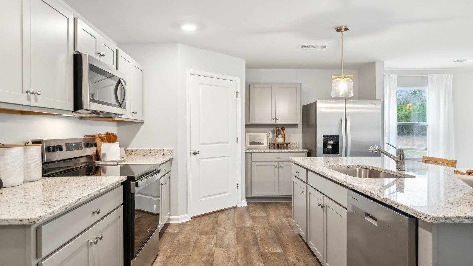 New appliances and larger kitchen island with seating anchor the kitchen, next to dining, family rooms provide stylish designs