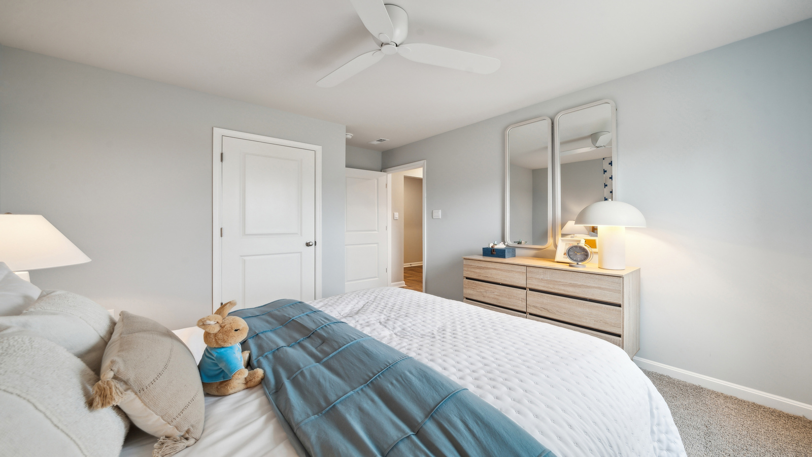 Secondary bedroom features a traditional closet, quality carpet, and a spacious room arrangement for flexible space design