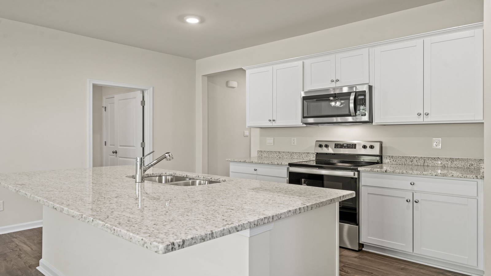 Island kitchen design at Spring Lakes offers fresh open concept design with new appliance suite, ample storage pantry