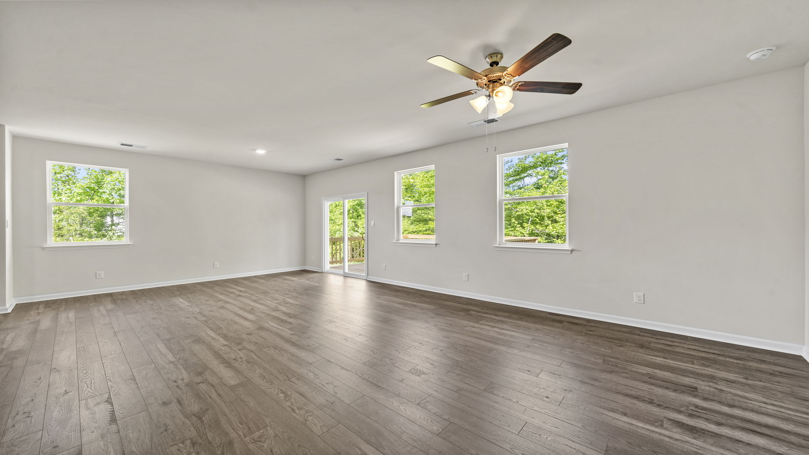 Kitchen island facing open-concept main living area with dining and family room access at Spring Lakes