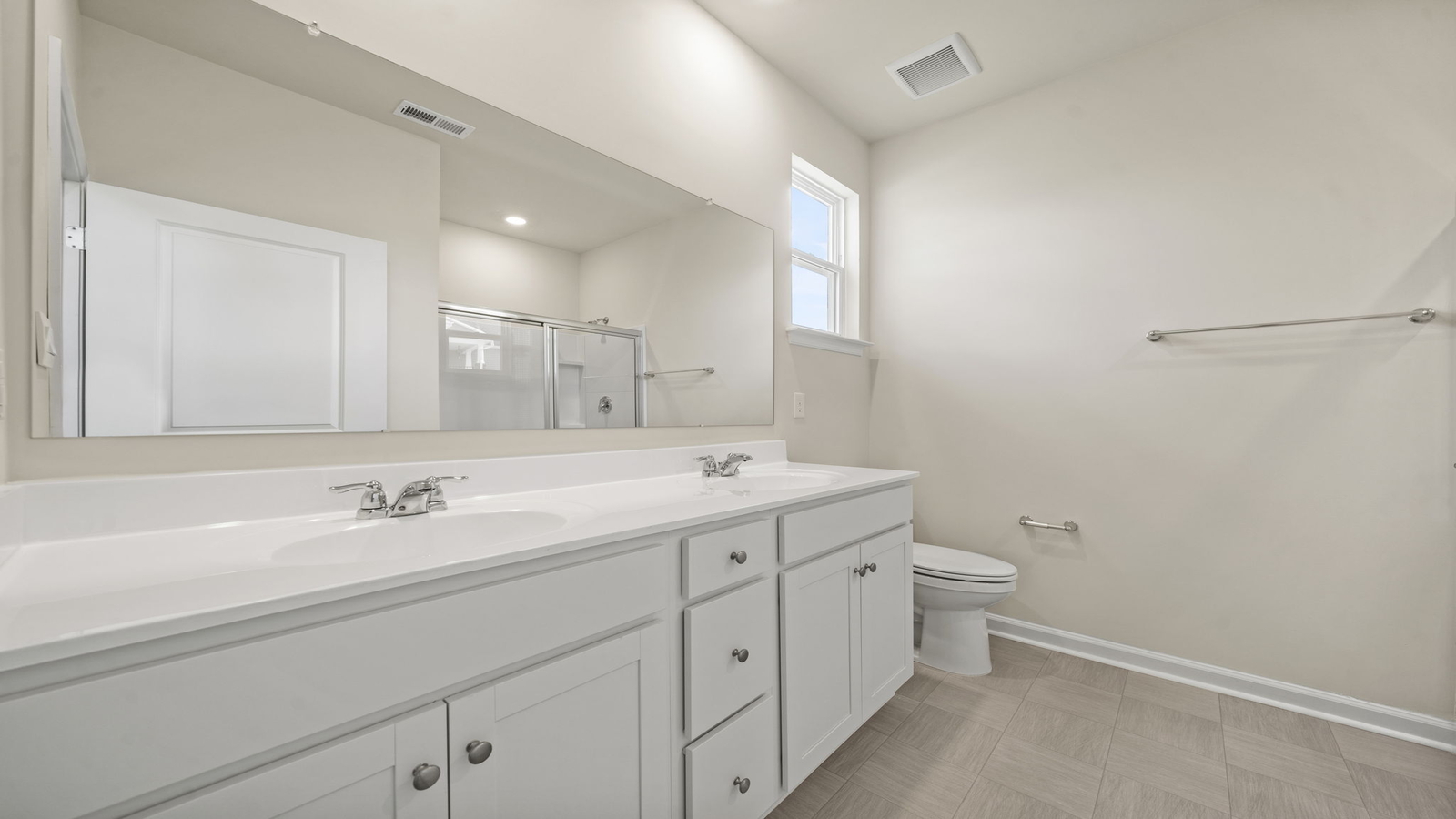 Owner’s ensuite in a new build home offers function with a walk-in closet, spa-like ensuite, stylish walk-in closet