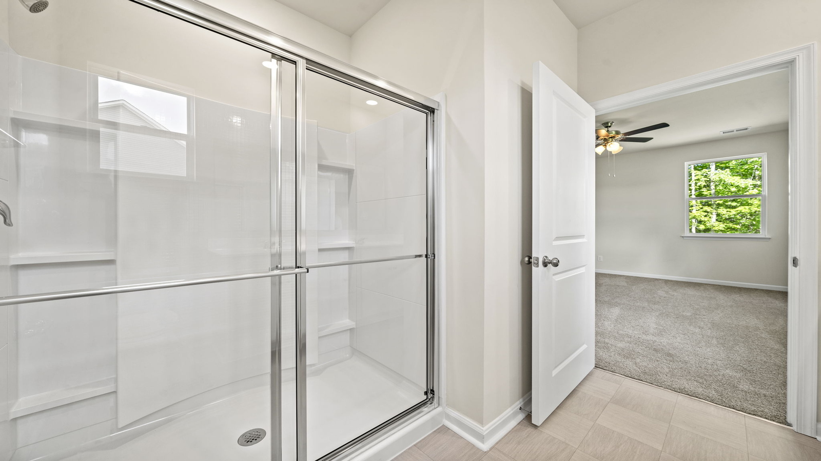 New construction home adds a thoughtful private ensuite, walk-in shower, walk-in closet, full vanity, mirror, backyard view