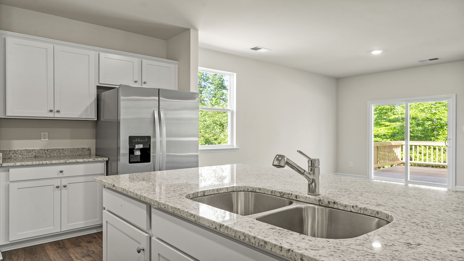 New home kitchen island with seating, pantry, ample cabinet storage, new appliance suite, multi-prep zones, outdoor access