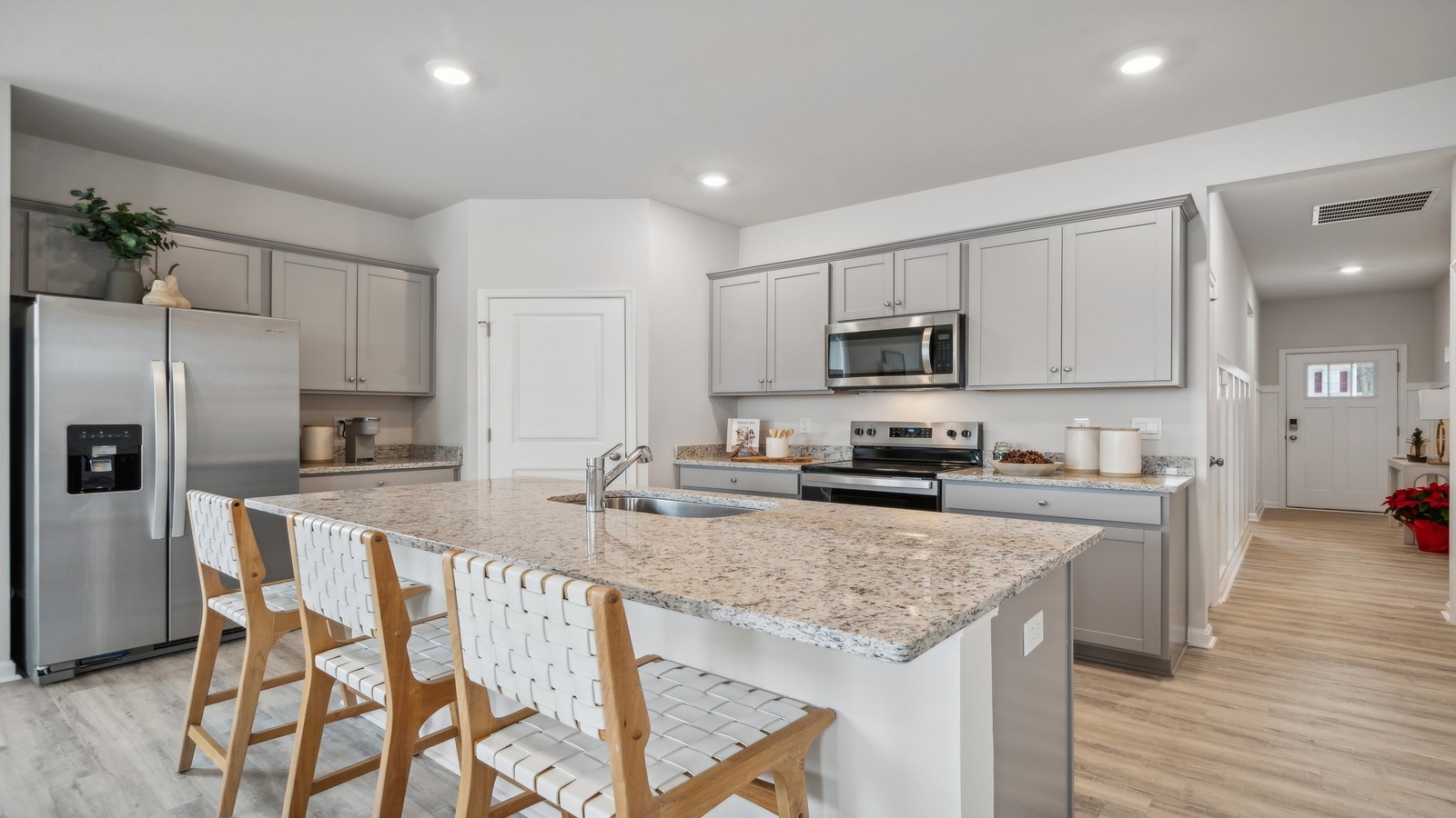 Kitchen, dining, family room blend together with ease of access to backyard view in D.R. Horton new home