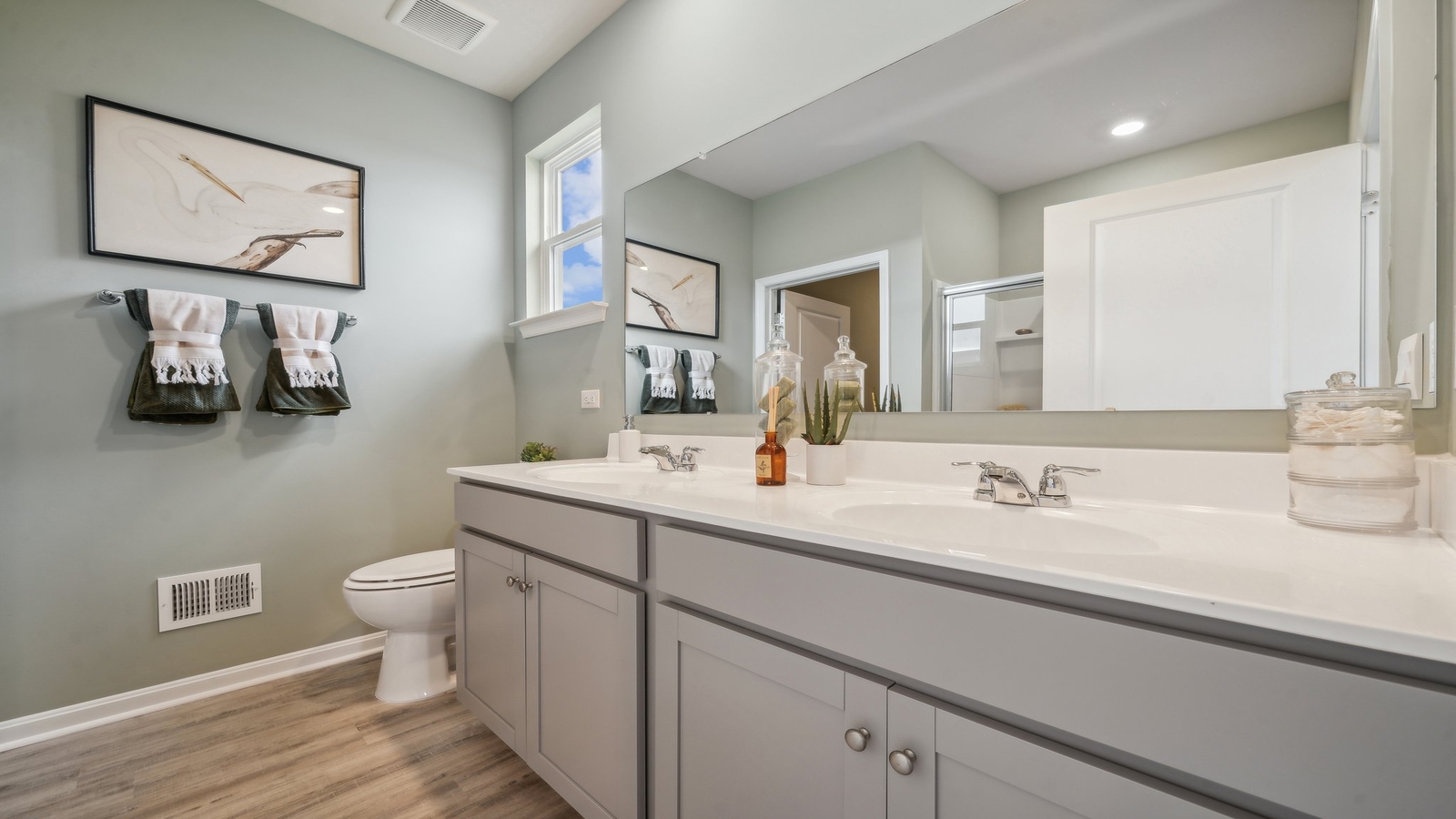 Owner’s ensuite in a new build home offers function with a walk-in closet, spa-like ensuite, stylish walk-in closet
