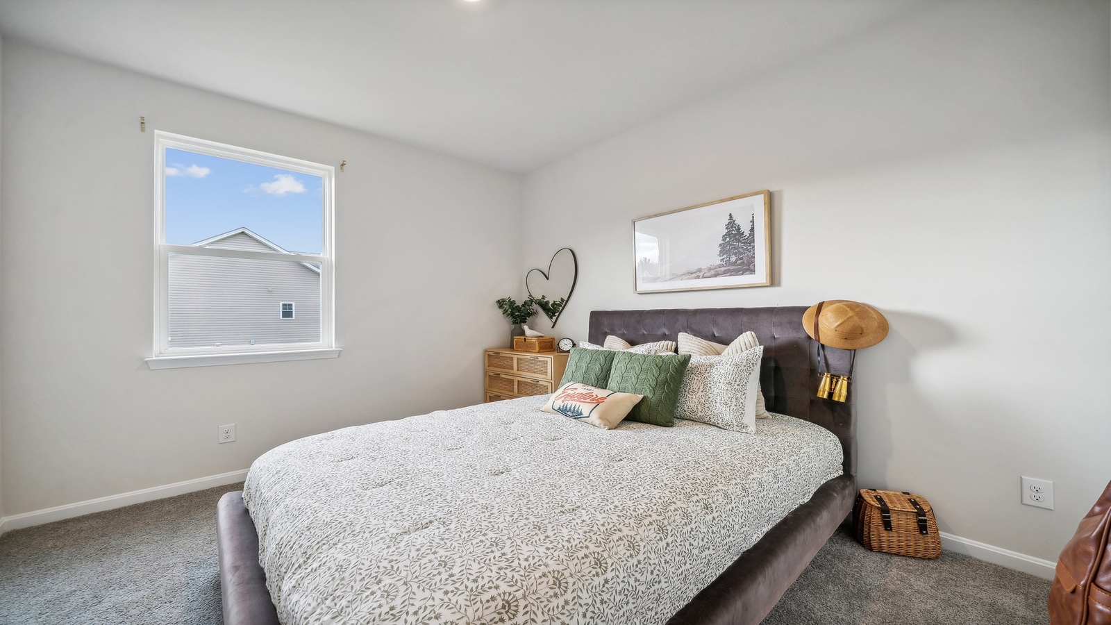 Secondary bedroom in this new home includes soft carpet, bright window light, closet, ideal for guest or child use