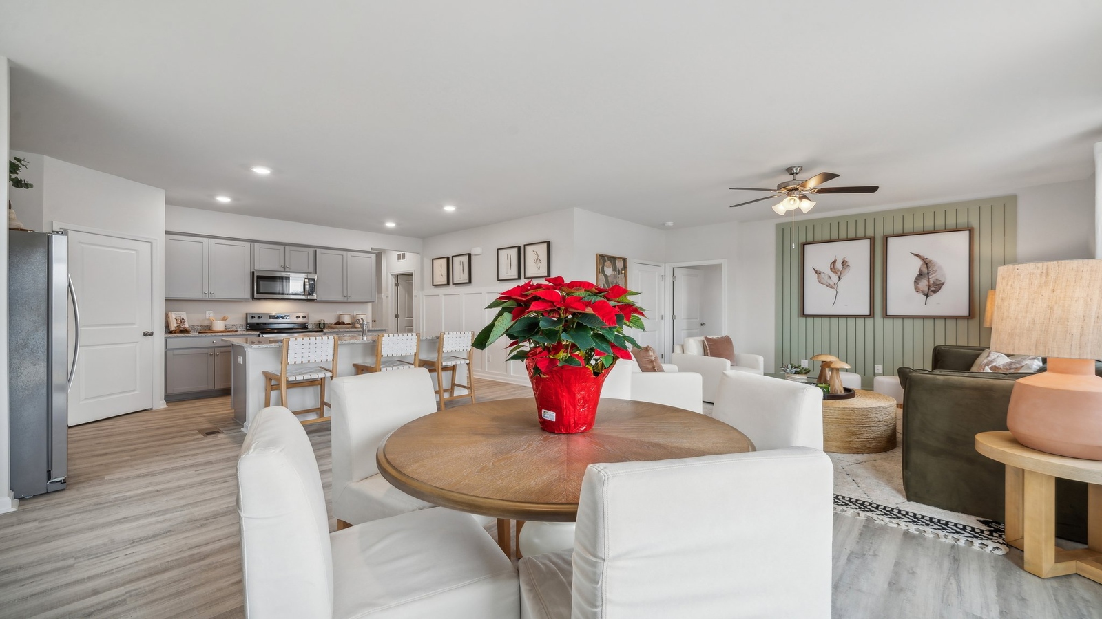 Dining area with open view into kitchen, and new appliance suite for modern living