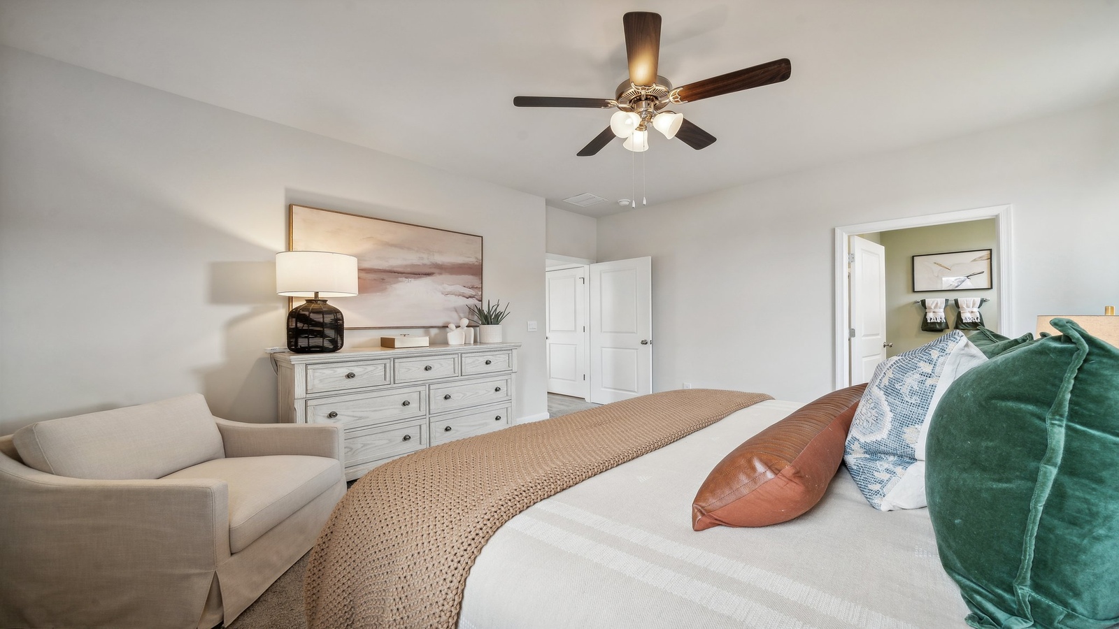 Primary bedroom features ample space, double windows, soft carpet, a stylish walk-in closet, and a private ensuite bath