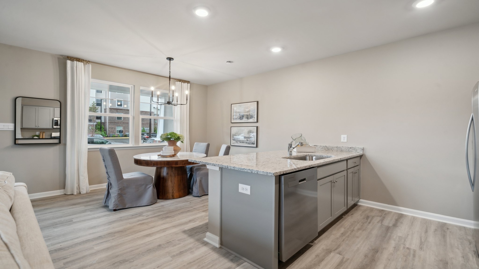 New townhome kitchen island with seating, pantry, ample cabinet storage, new appliance suite, and multi-prep zones