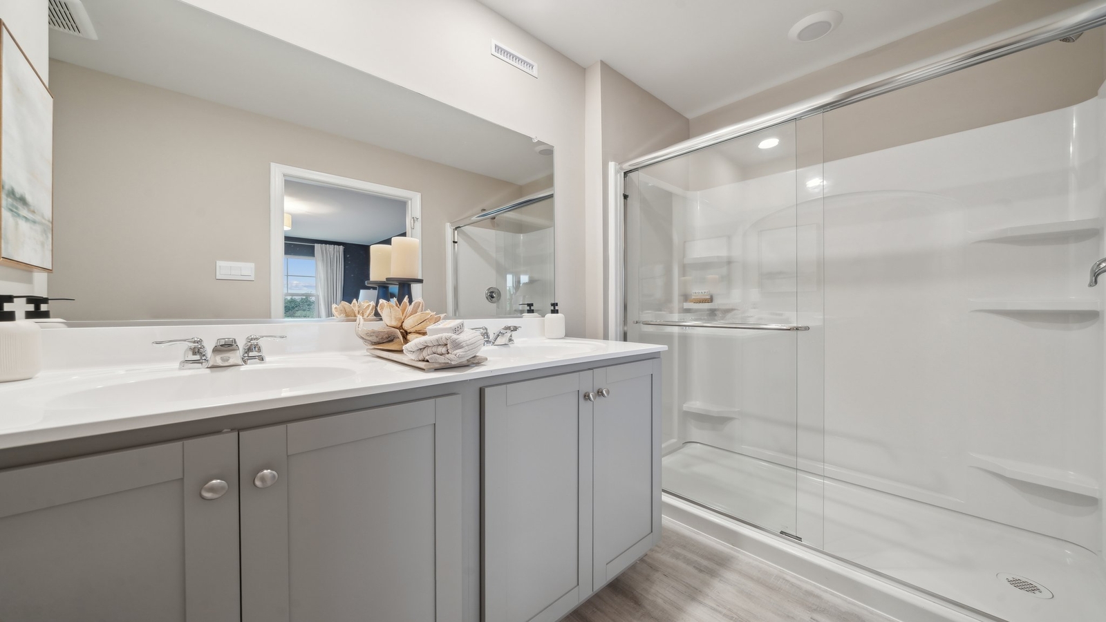 Primary ensuite in D.R. Horton's new townhome featuring an expansive vanity with dual sinks, shower, tub, walk-in closet