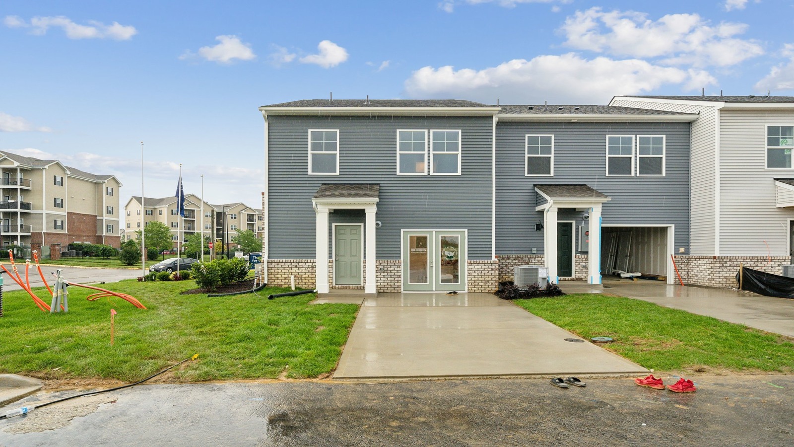 Sideyard with concrete patio area offering room for seating, grill setup, and a transition from indoor to outdoor living