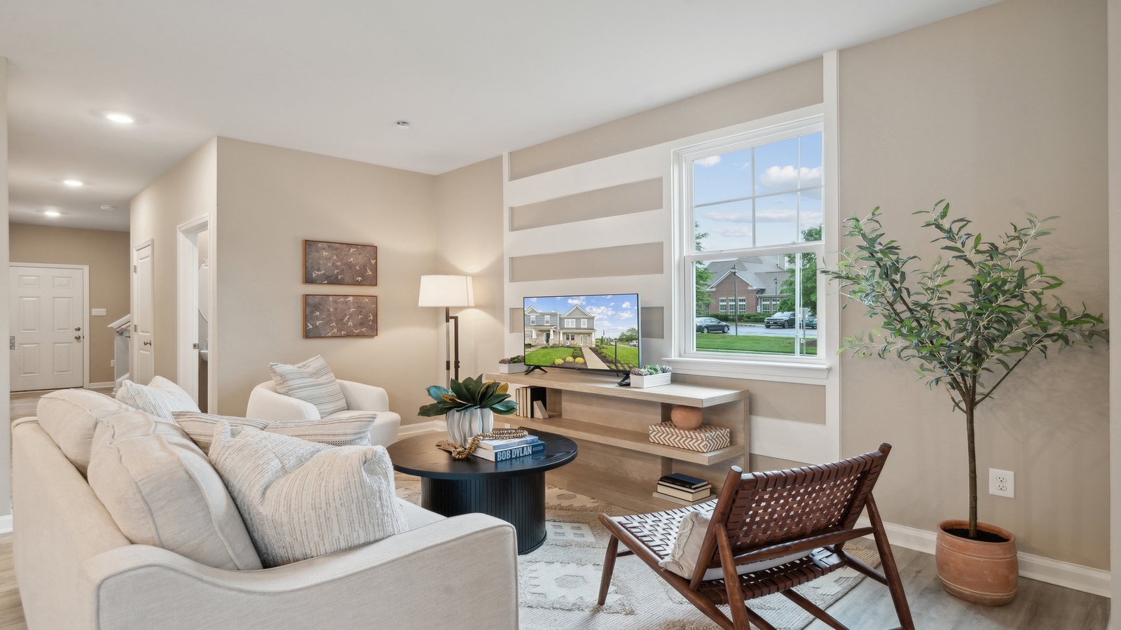 Main front level living room adds a bright space, open concept connections to kitchen, living spaces, stairs