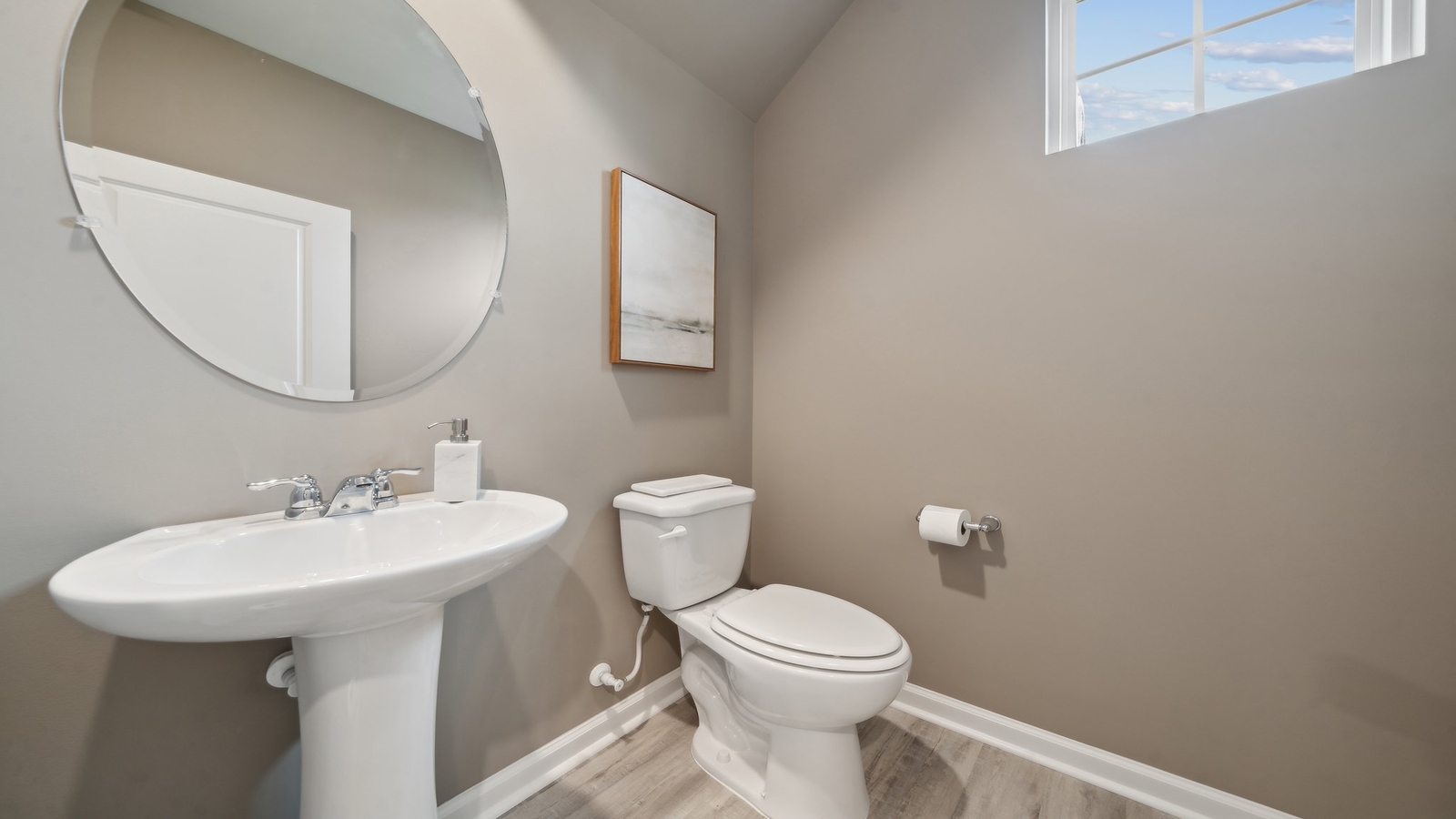 Half bath with white pedestal sink, single-lever faucet, and wall-mounted mirror in Chappell Creek