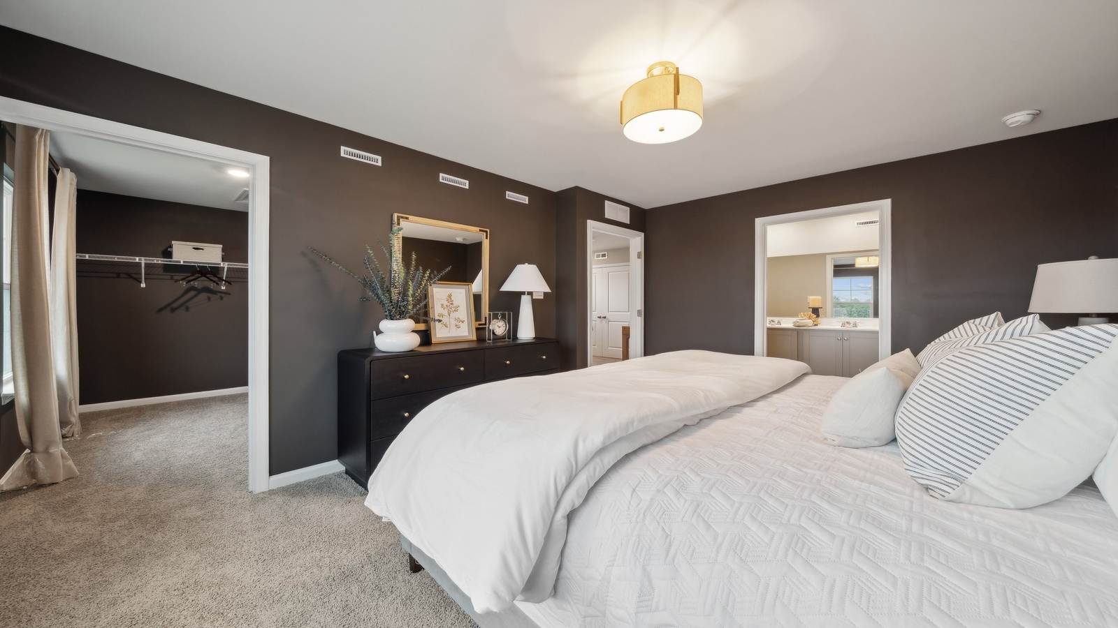 Primary bedroom designed for privacy and space with a convenient flow into spa-inspired ensuite bathroom and walk-in closet