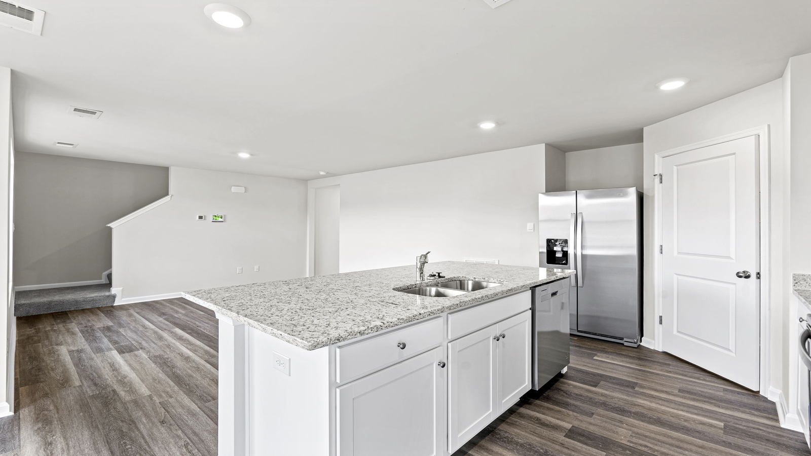Bright kitchen with center island, Pantry, hard surface countertops, brand-new appliances in Arbors at Farms of New Kent