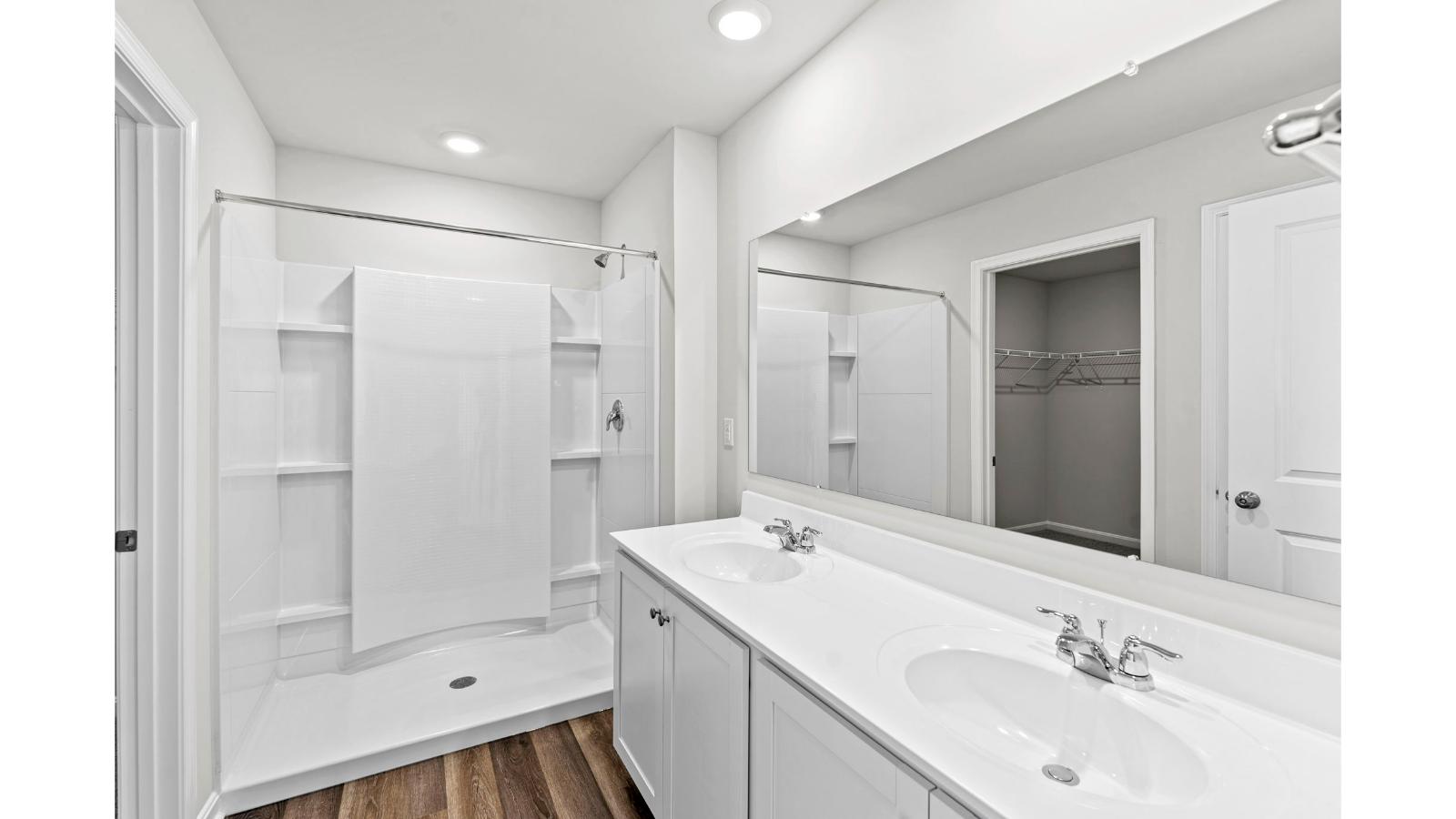 Owner’s en-suite new build home offers a functional layout with a walk-in closet, and spa-like en-suite shower-bath designs