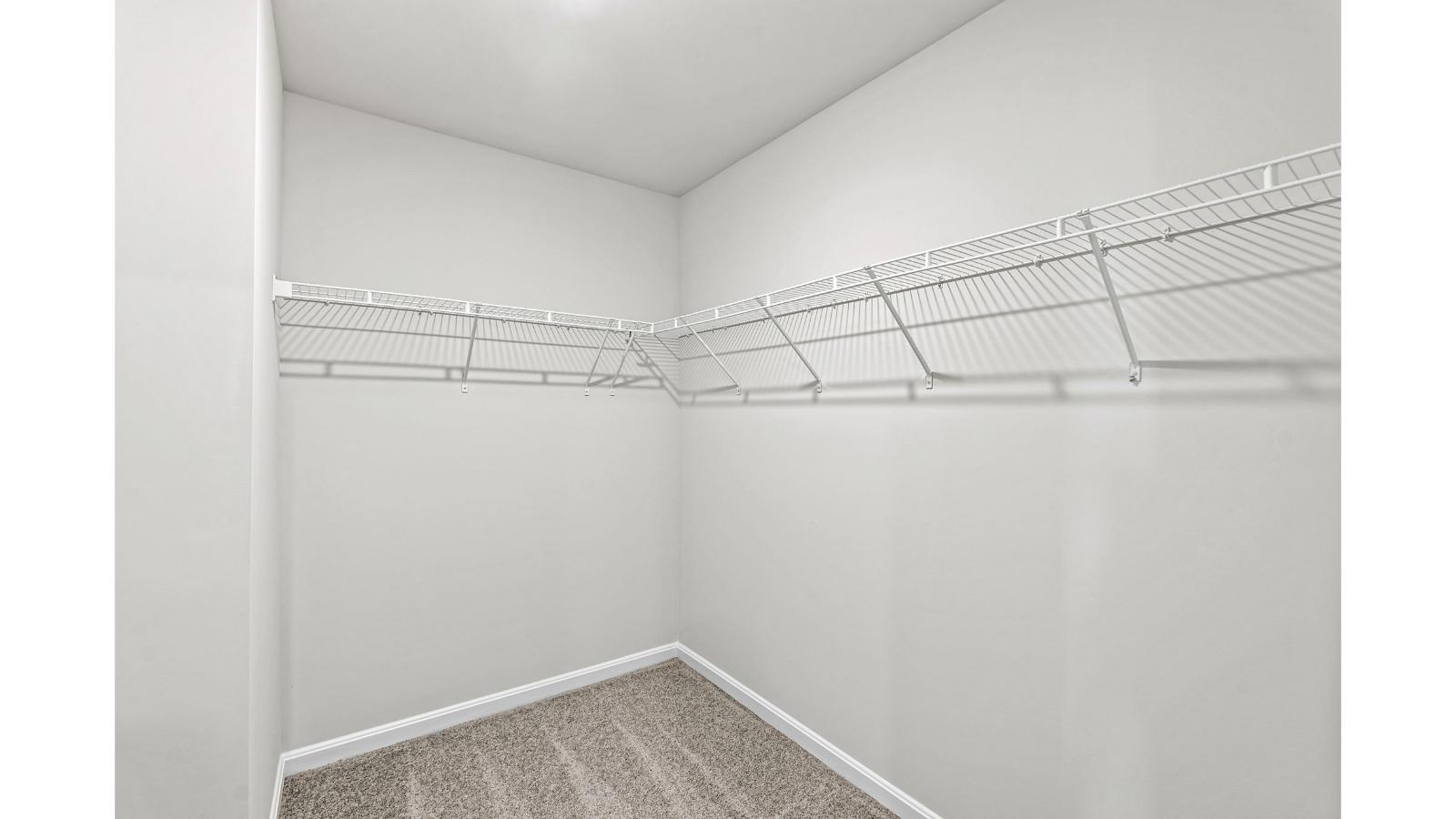 New home primary walk-in closet designed by D.R. Horton in Arbors at Farms of New Kent with crafty organized space