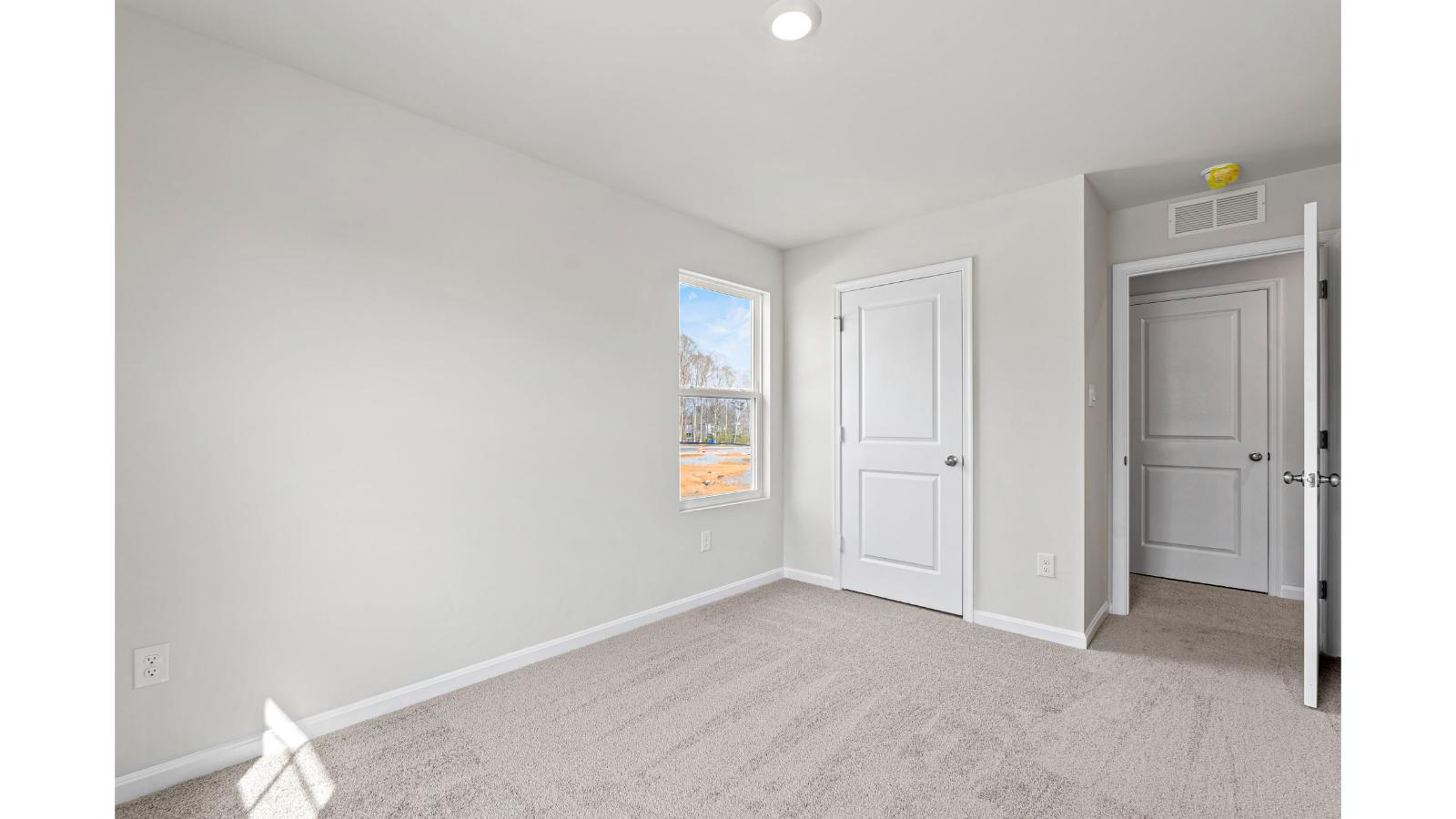 Primary bedroom in this New Home features ample space, double windows, soft carpet, a Walk-in Closet, private En-Suite Bath