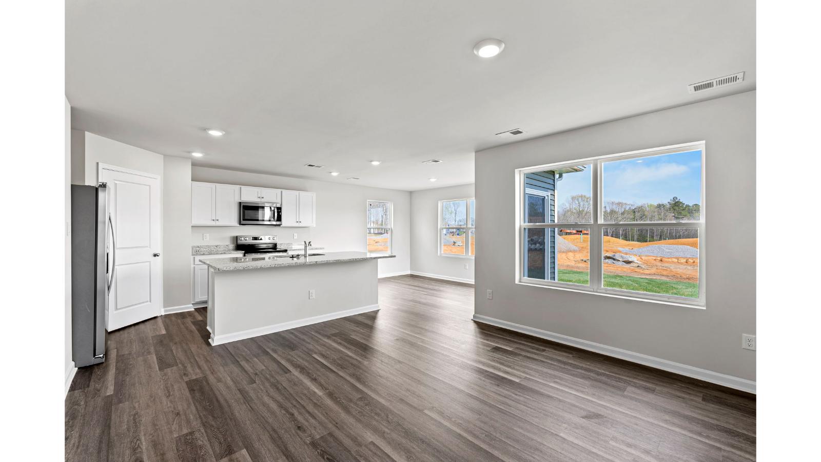 Arbors at Farms of New Kent's Kitchen island seamless design integration with dining- living areas and Open Concept design