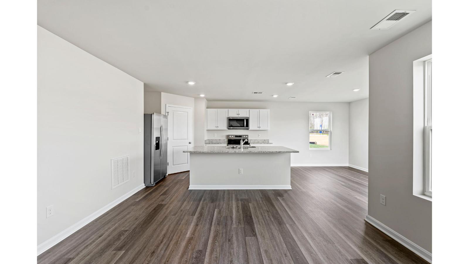Kitchen island in this D.R. Horton New Home featuring Hard Surface Countertops and New appliances