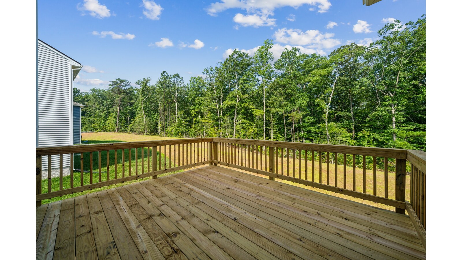 Functional backyard design with back deck, rear concrete patio shade structure located in a planned community