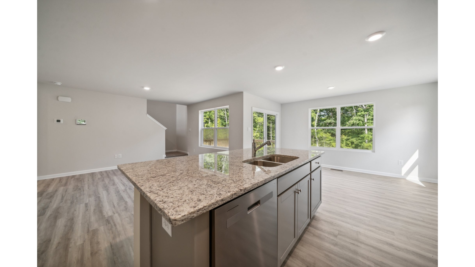 New Home kitchen island with bar seating and ample cabinet storage and pantry, sizable cooking zones