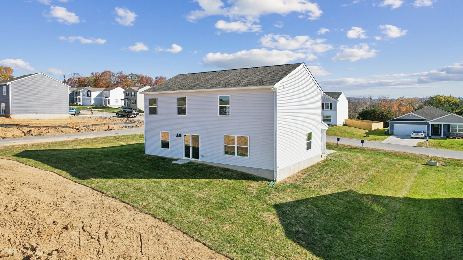 Backyard deck at main living level in this New Home with lawn, concrete patio slab, and fencing potential for added privacy