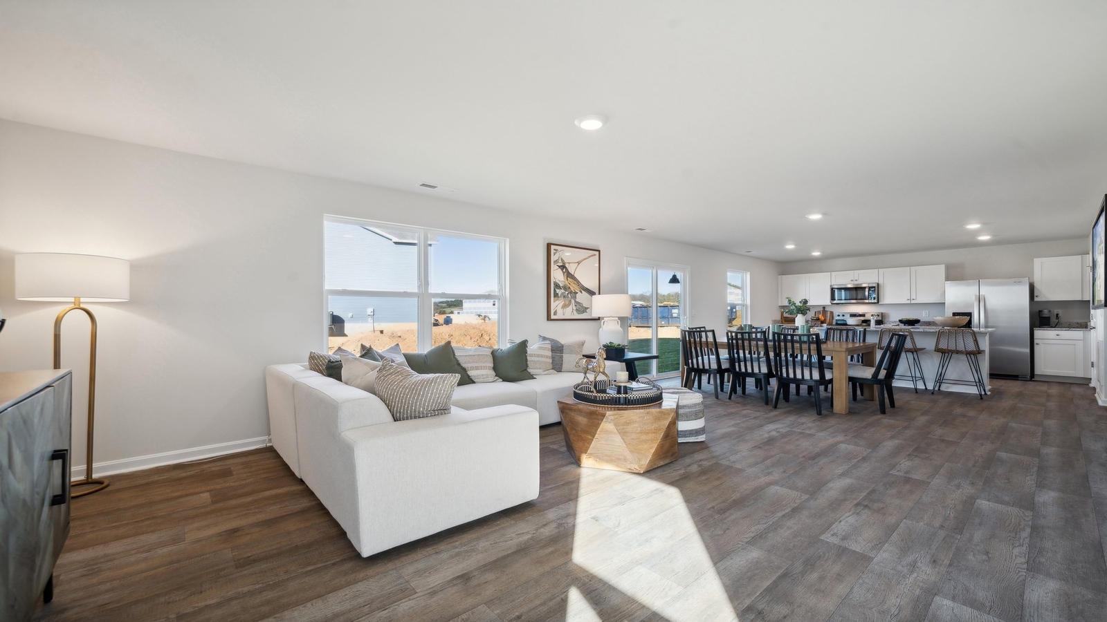 Living room designed by D.R. Horton showcases neutral paint, durable flooring, and access to the rear deck