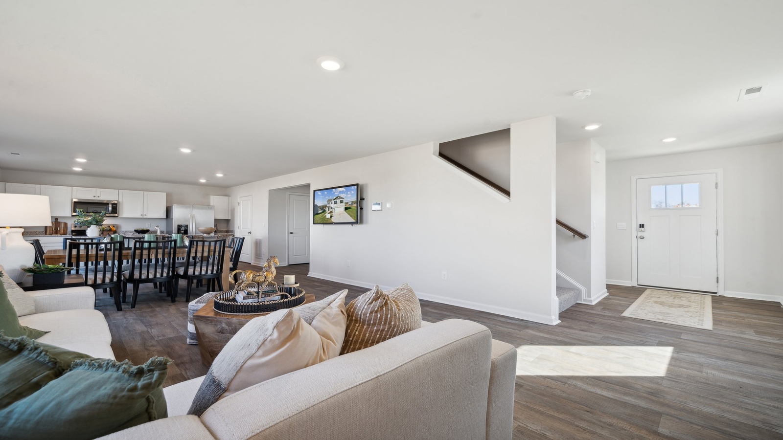 Bright living room with direct connection to dining nook and kitchen island in this New Construction House