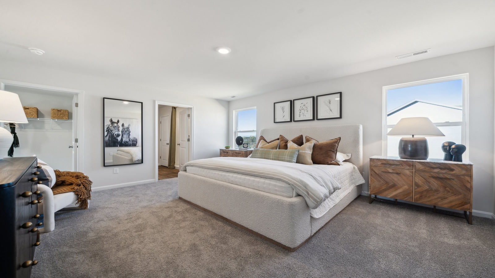 Primary bedroom in this New Home features ample space, double windows, soft carpet, a Walk-in Closet, private En-Suite Bath