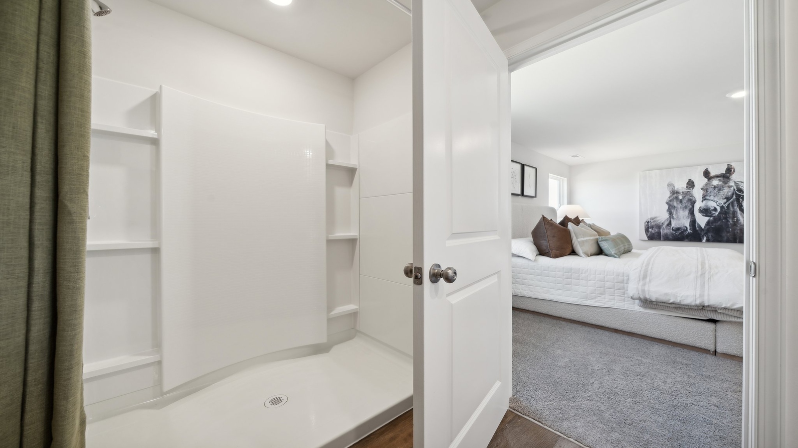 New Construction Home by D.R. Horton includes a private en suite, walk-in shower, hard surface countertops, and ample lighting