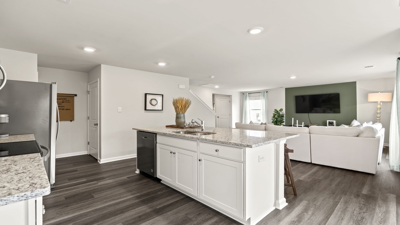 Central kitchen island with seating anchors our main level with meal prep zones, new appliance suite, dining-living areas