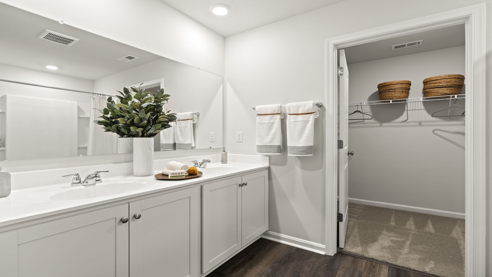 Primary en-suite bathroom in this D.R. Horton New Home featuring dual sinks, expansive vanity, shower-tub, Walk-in Closet