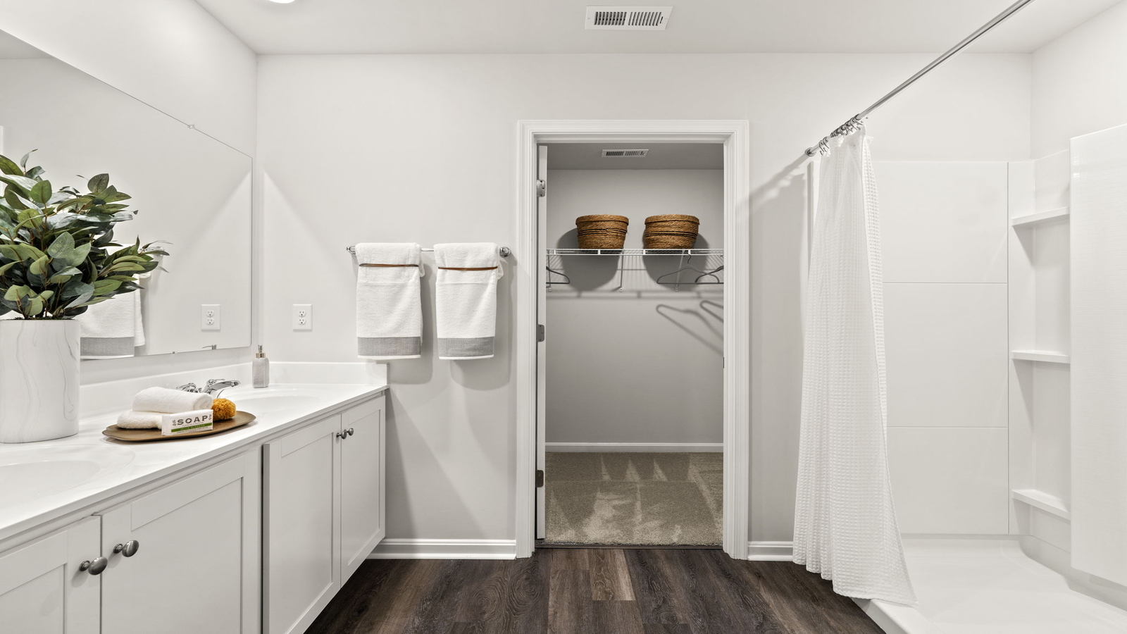 New home primary walk-in closet designed by D.R. Horton in Arbors at Farms of New Kent with crafty organized space